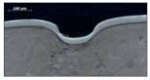 Cross section of treated stainlesssteel AISI 316L after rapid heavy deformation (hammer & nail test)